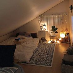 an attic bedroom with lights and rugs on the floor