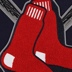 a close up of a baseball bat and glove on a rug in the shape of a boston red sox logo