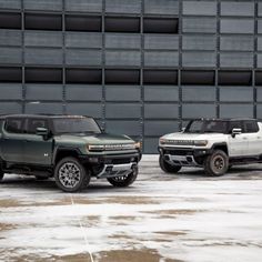 two trucks parked next to each other in front of a building