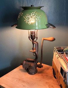 a lamp that is sitting on top of a wooden table next to a toy truck