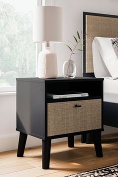 a night stand with two drawers and a lamp on the end table next to it