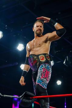 a man standing on top of a wrestling ring