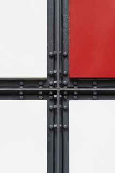four square white and red panels with rivets