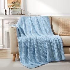 a couch with a blue blanket on top of it