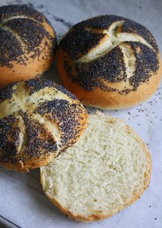 three loaves of bread sitting on top of a piece of parchment paper next to each other