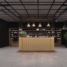 an empty bar with lots of bottles on the counter and lights hanging from the ceiling