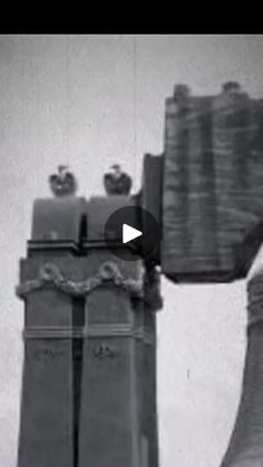 an old black and white photo of two bell towers with apples on top in the background