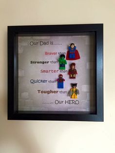 a shadow frame with legos on it and the words our dad is, braver than smarter than quicker than tougher than our hero