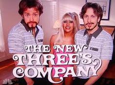 three people standing next to each other in front of a sign that says the new three's company