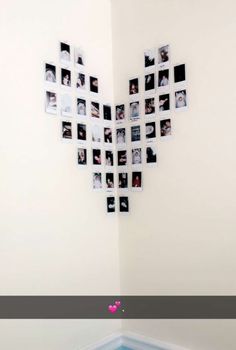 a heart shaped wall hanging on the side of a white wall with photos attached to it