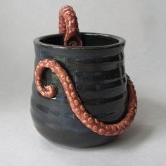 an octopus is curled up in a cup