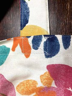 a close up view of the fabric on a table cloth with flowers printed on it