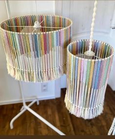 two lampshades made out of strips of yarn