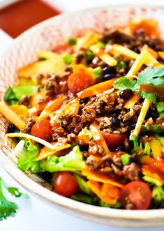 a salad with meat and vegetables in a bowl