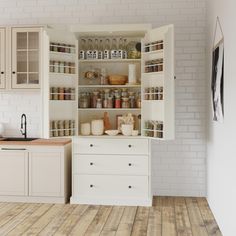 an open cabinet in the middle of a kitchen with wooden floors and white walls, filled with various items