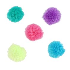 four different colored pom poms on a white background