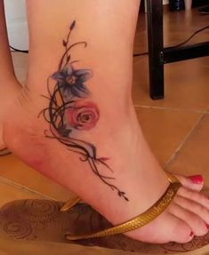 a woman's foot with a rose tattoo on it