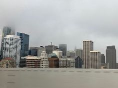 a city skyline with tall buildings in the foreground