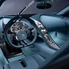 the interior of a bugatti car with blue leather and chrome trimmings