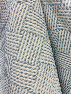 an up close shot of a blue and white patterned fabric