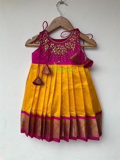 READY TO DISPATCH. Size available-0-2 years The yoke portion of the frock is made of soft silk fabric and the skirt portion is made of Kanchipuram silk fabric. The yoke portion embellished with kundan stones and zardozi. The dress is fully lined with cotton fabric. The stitches are concealed. Please Visit Our Shop For More Unique Collection https://www.etsy.com/shop/Chitralie BUYER'S PLEASE LEAVE YOUR CONTACT NUMBER. It's necessary for shipping Kerala Half Saree, Kids Party Wear Frocks, Onam Dress, Party Wear Frocks, Frocks For Kids, Saree Blouse Styles, Baby Girls Dresses, Sarees For Girls, Kids Party Wear