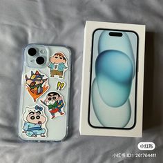 an iphone case with cartoon stickers on it next to a box for the phone