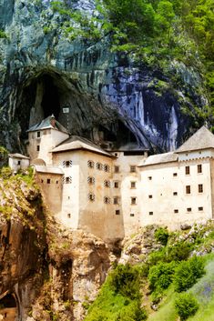 an old castle built into the side of a mountain