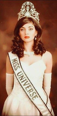 an old photo of a woman wearing a tiara and holding her hand on her hip