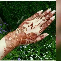 a woman's hand with henna on it and the number one painted on it