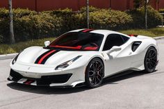 a white and red sports car parked on the street