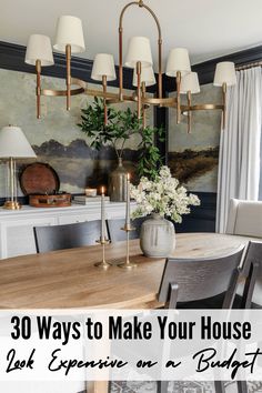 a dining room table with chairs and a vase filled with flowers on top of it