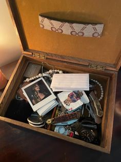 an open wooden box filled with personal items