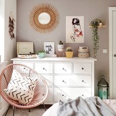 a bedroom with a bed, dresser and mirror