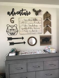 a baby's nursery wall with an arrow, deer head and arrows on it