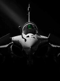 an airplane is shown in black and white with green light coming from the front end