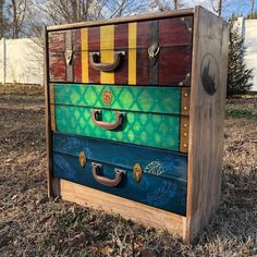 an old trunk has been painted with different colors