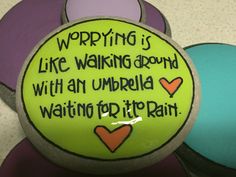 there is a green and purple ball with writing on it that says, worrying is like waking around with an umbrella waiting for it rain