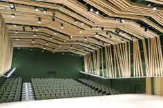 an empty auditorium with rows of seats and lights