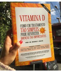 a person holding up a book about vitamin d