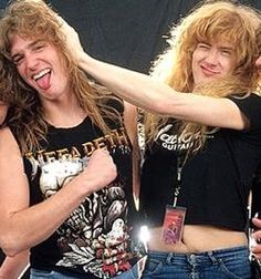 two young women standing next to each other with their arms around one another and smiling at the camera