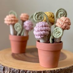 small crocheted flowers are sitting in a pot