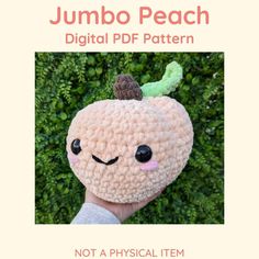 a hand holding up a stuffed toy with a face on it's head and the text jumbo peach digital pattern not a physical item