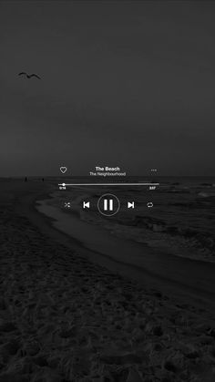 black and white photo of the beach with music player on it's headphones