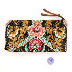 "Atenti Jaya Tall Tool Accessory Pouch is a exotic tiger print. This is a case to hold your larger tools which is fully lined in tan taffeta. This vegan pouch can be used for crafting tools, pencil bag, crochet tools, sewing notions-anything you need to organize and move. All pieces are hand made, unique and made in the USA. Tool Pouch measures: 10.\"\"W x 5\" H x 1\" base. Photo 1  are the front of the tool case in the listing  Photos 2-5 are of a similar bag Photo 2 shows the backside fabric. Listing is for the Tool Pouch as shown in Photo #1 All tools are for display purposes only. Matching Jaya Tall Caddy:  Cat Tape Measure: www.etsy.com/listing/670232332/cat-tape-measure-60-retractable-tape Custom orders for Atenti bags upon request. Choose Priority Upgrade to fast track your order. O Knitting Needle Case, Notions Bag, Bag Knitting, Crafting Tools, Crochet Tools, Tool Pouch, Tool Case, Pencil Bag, Needle Case