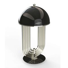 a black and chrome table lamp sitting on top of a white floor