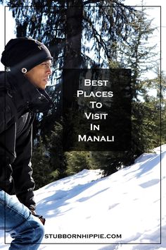 a man riding a snowboard down a snow covered slope next to a pine tree