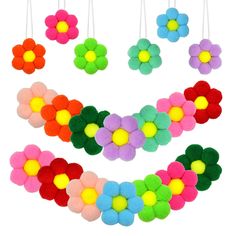 colorful felt flower decorations hanging from strings