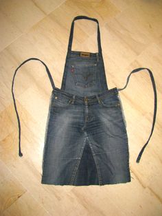 a pair of blue denim overalls on the floor