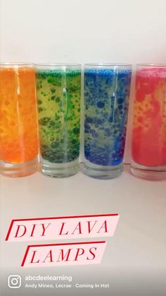 four glasses filled with different colored liquids on top of a white table and the words diy lava lamps above them