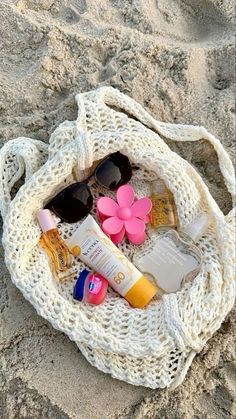 the beach bag is filled with sunscreens and other personal care items on it